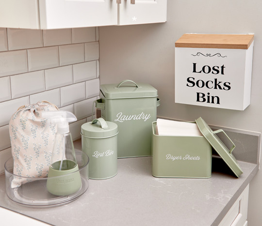 Laundry organization essentials from Clean Mama: tin organization containers, glass spray bottle, and more.