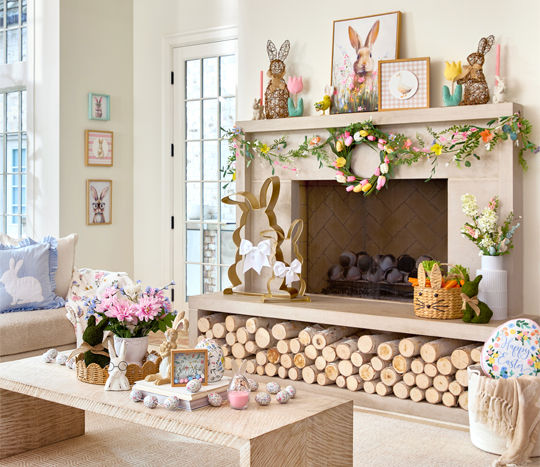 Living room decorated with Easter decor from pOpshelf: metal and rattan bunnies, framed bunny art, egg garland, pillows, bunny & carrot decor, and more.