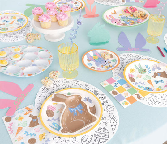 Pastel Easter party supplies and decorations featuring a giant foil bunny balloon, bunny easter goodie bags, and bunny & easter basket themed plates, cups, and napkins.