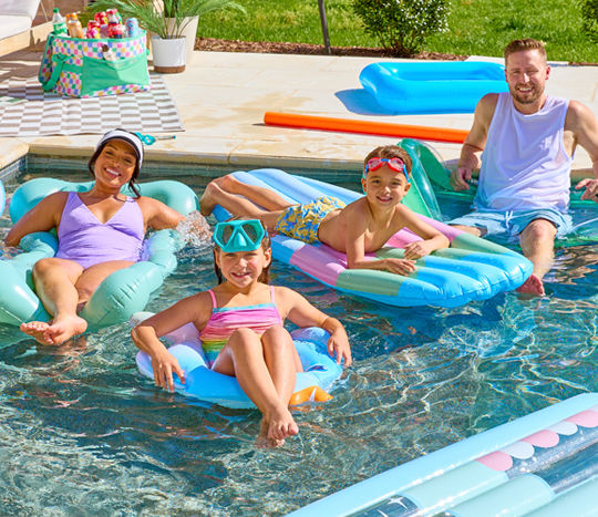 Family floating in pool on various rafts, floats, and pool rings from pOpshelf.