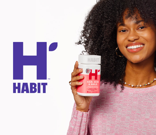 Woman holding a bottle of Habit vitamins from popshelf.