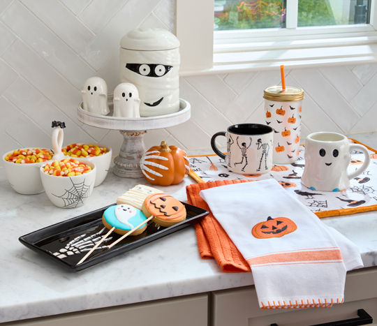 Halloween kitchen accents: mummy canister, ghost and skeleton mugs, ghost salt & pepper shakers, kitchen towels and mats, and other decor.