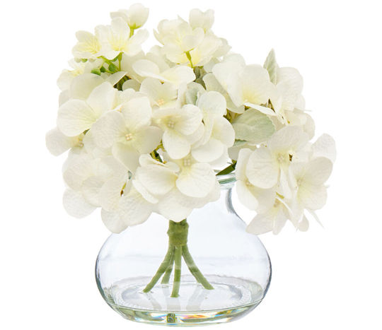 artificial magnolias in glass vase