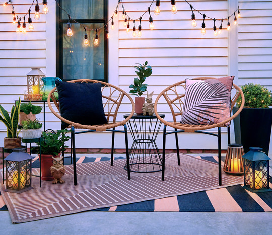 Outdoor string lights and solar lanterns from pOpshelf on a backyard patio.