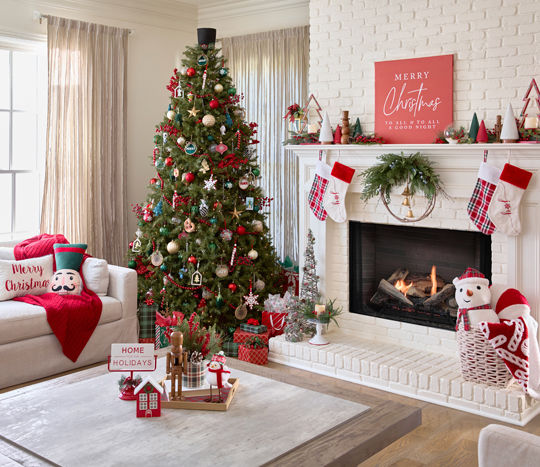 Living room and tree decorated with "modern classics" Christmas decor in traditional colors of white, green, and red..