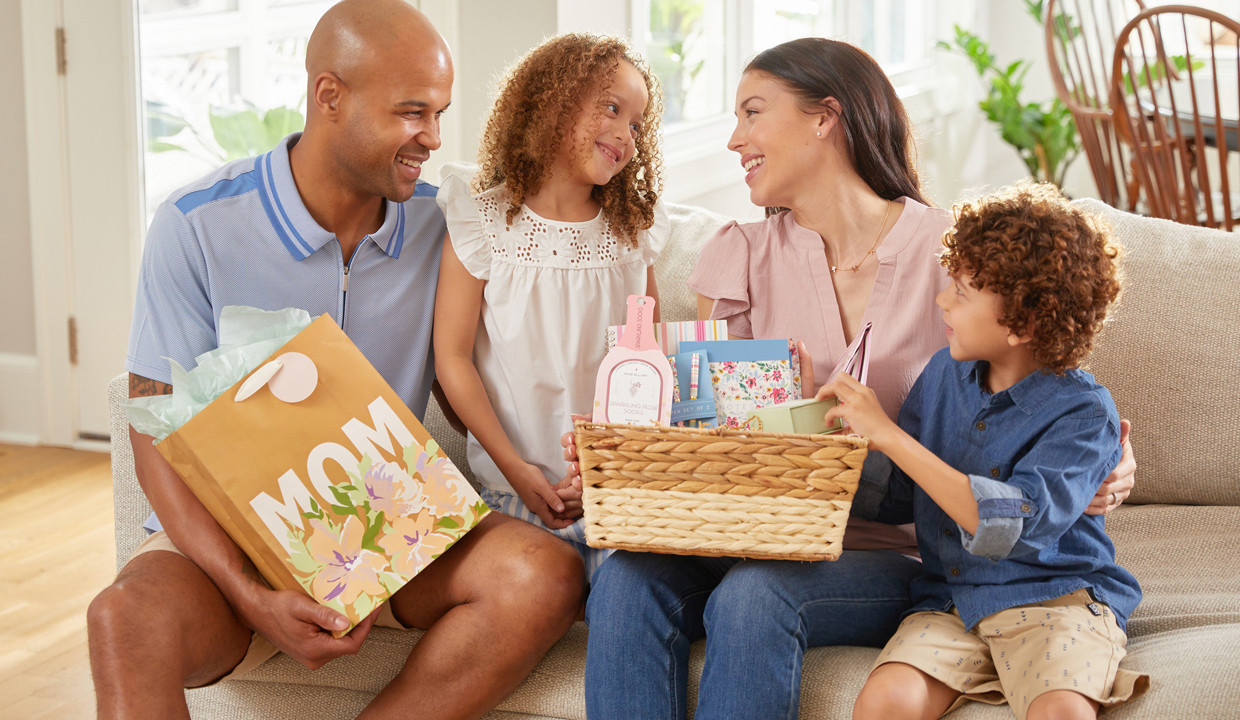 Mother, father, and kids giving mom Mother's Day gifts from pOpshelf.