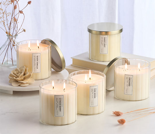 lit glass ribbed candles surrounded by dried florals