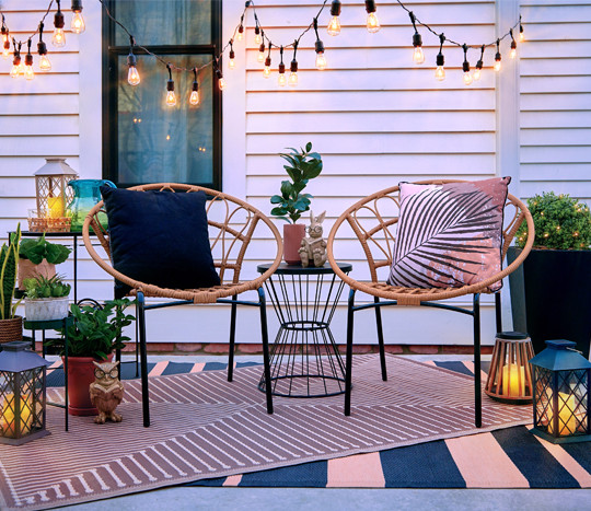 Backyard with outdoor patio furniture and chairs, outdoor rugs & pillows, garden & patio decor, and string lights from pOpshelf.