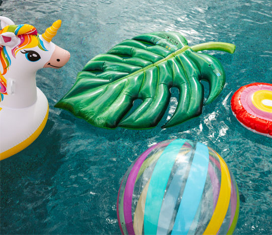Unicorn, ball and leaf pool floats in pool.
