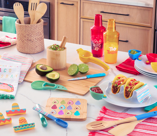 Accessories for the perfect taco night: cutting board, salsa spoons, mortar & pestle, avocado slicers, taco holders, cocktail shakers, and kitchen linens.