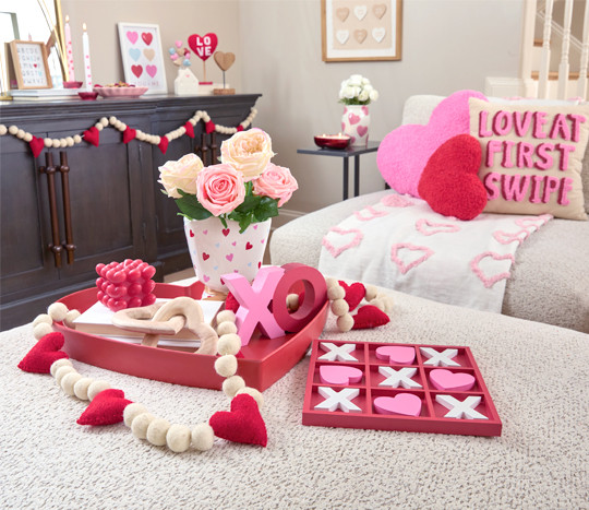 Living room decorated with pOpshelf Valentine's Day home decor pieces: heart pillows, heart wall art, Valentine's candles, and valentine's day decor items.