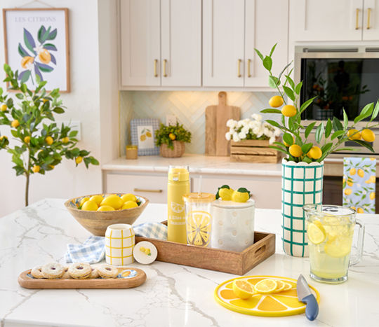 Lemon-themed decor and kitchen accessories: candles, travel cups, lemon tree, vases, wooden bowls, trays & more.