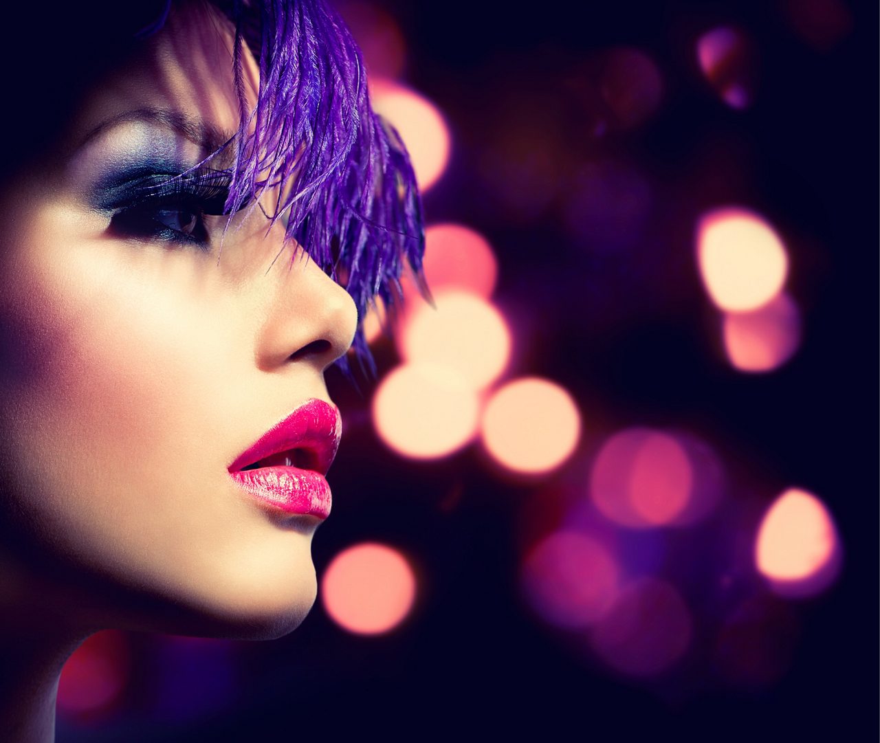 Woman with purple hair, pink lipstick, and smooth skin
