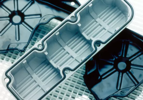 Automotive engine valve cover and timing-belt cover show silicone rubber formed-in-place gaskets. This image is also available in bright blue.