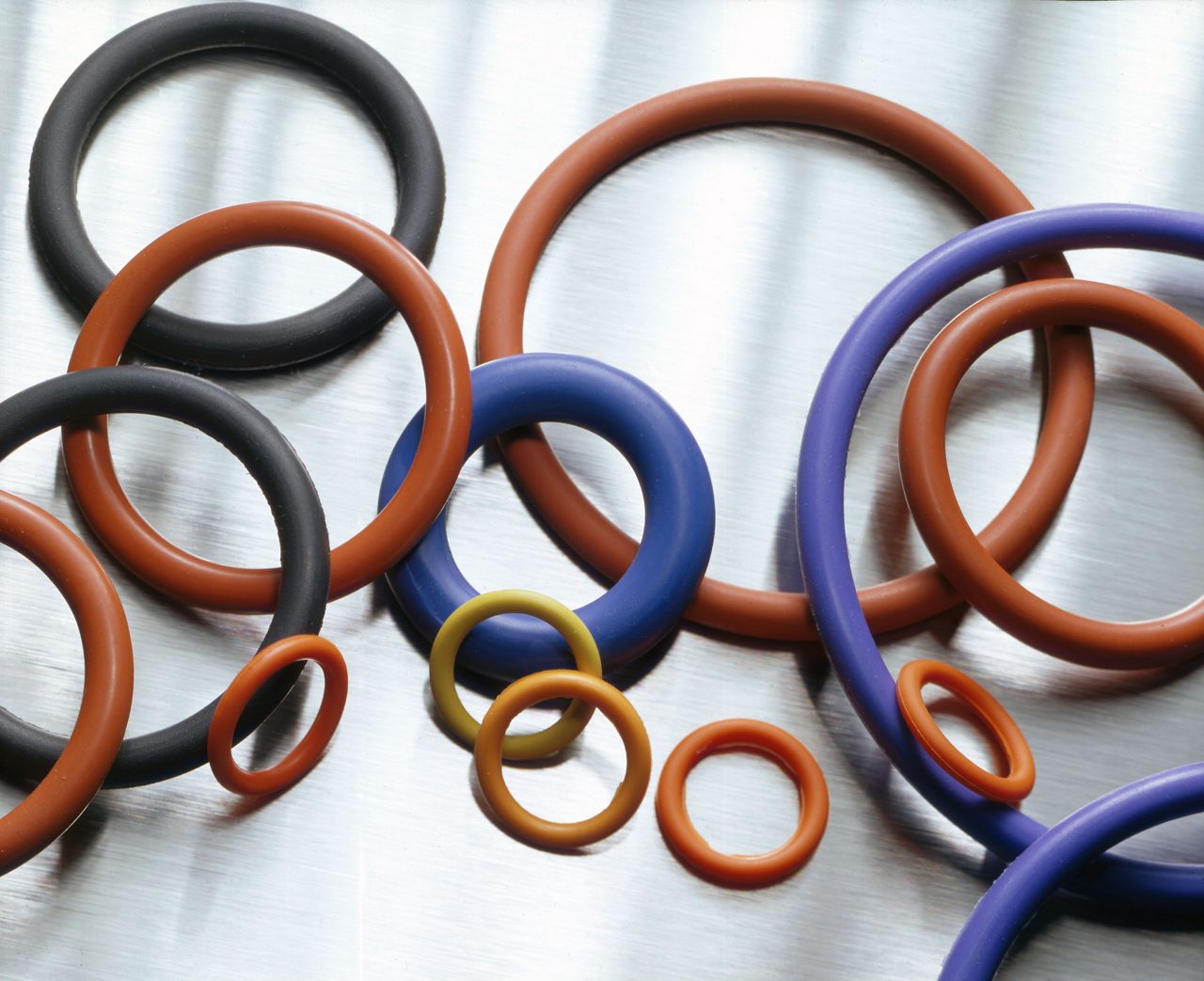 O-rings made from Fluorosilicone Rubber over metallic background