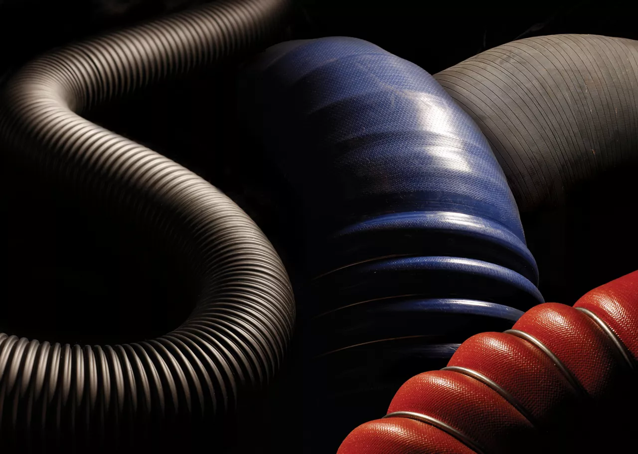 Automotive hoses on a black background.