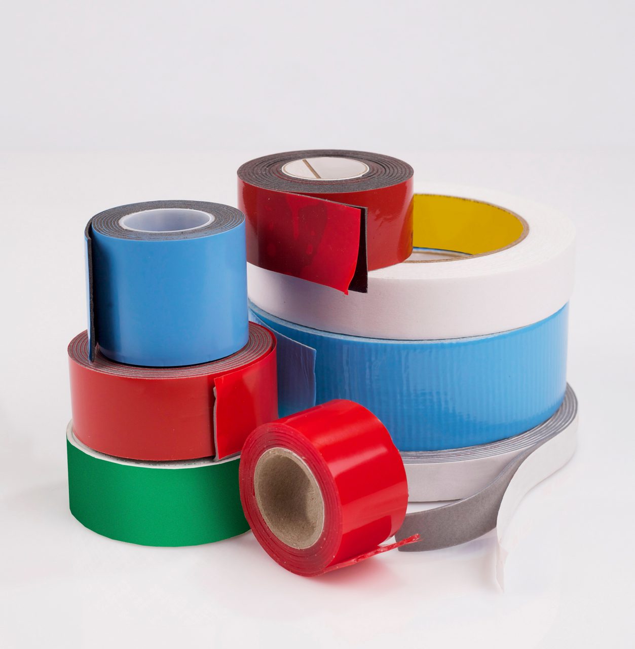Various rolls of tape on a white background