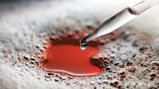 Glass eyedropper dispenses silicone antifoam into a foam covered liquid. The liquid is red. Reference AV03988 Edited by AGP For use on Dow Corning 102F additives website. "Power up your coatings with effective foam control."