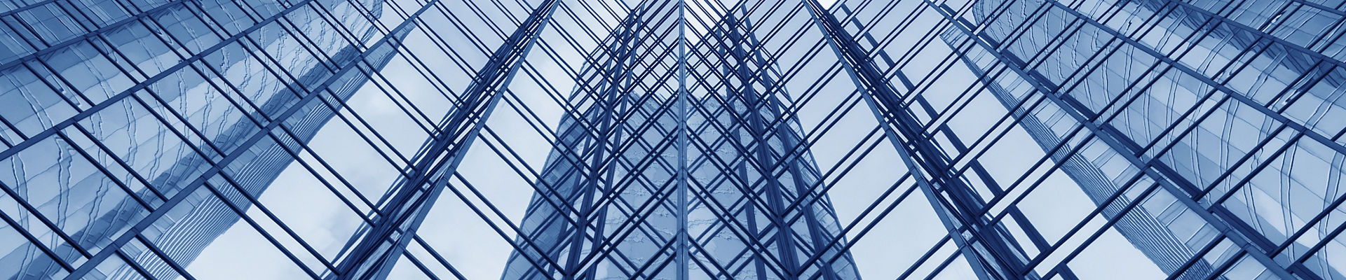 Looking up at the glass façade of a modern office building