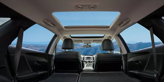 View of car interior from backseat looking forward to mountains ahead