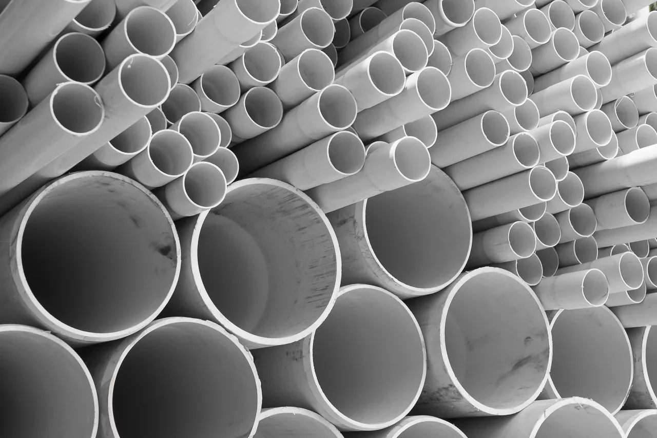 PVC pipes stacked in warehouse.