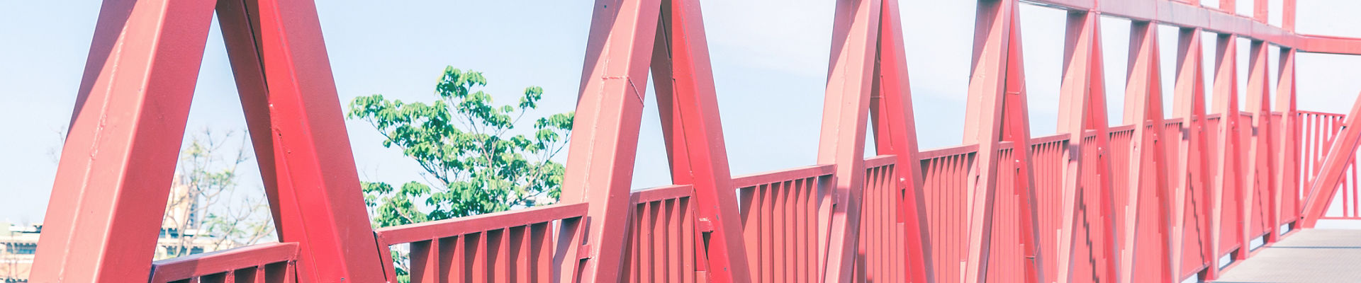 Iron truss footbridge painted in vivid red