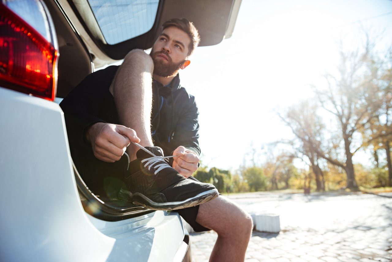 Runner tying shoe