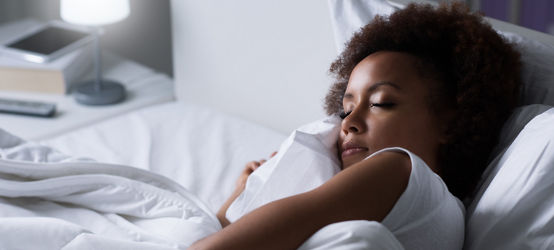 Woman sleeping in her bed at night 