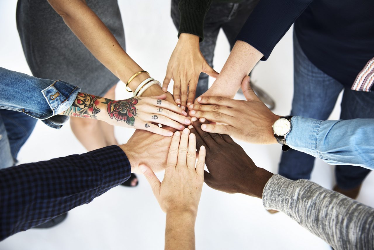Eight multiracial teamwork hands