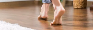 Woman walking on heated floor wood panel 