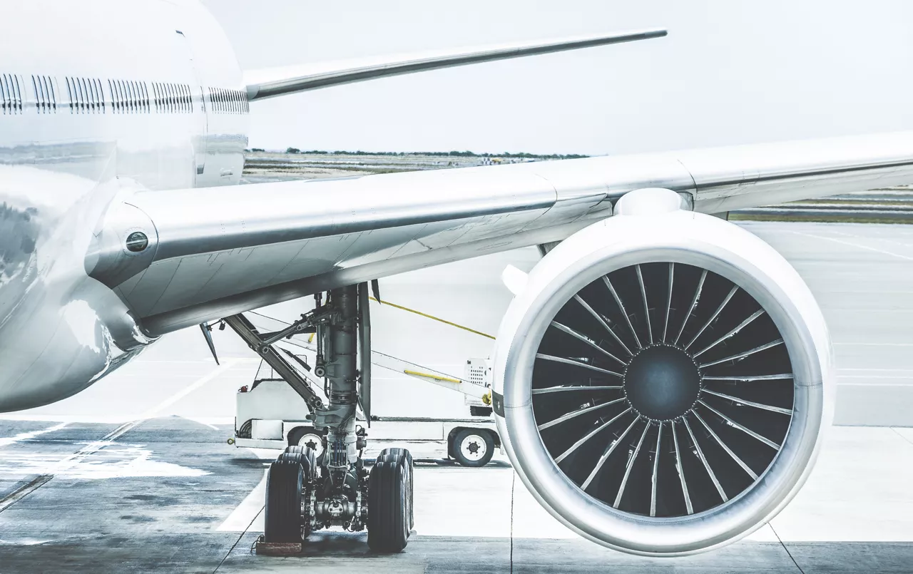 Detail of airplane wing engine at terminal gate before takeoff - Wanderlust travel concept around the world with air plane at international airport - Retro contrast filter with light blue color tones