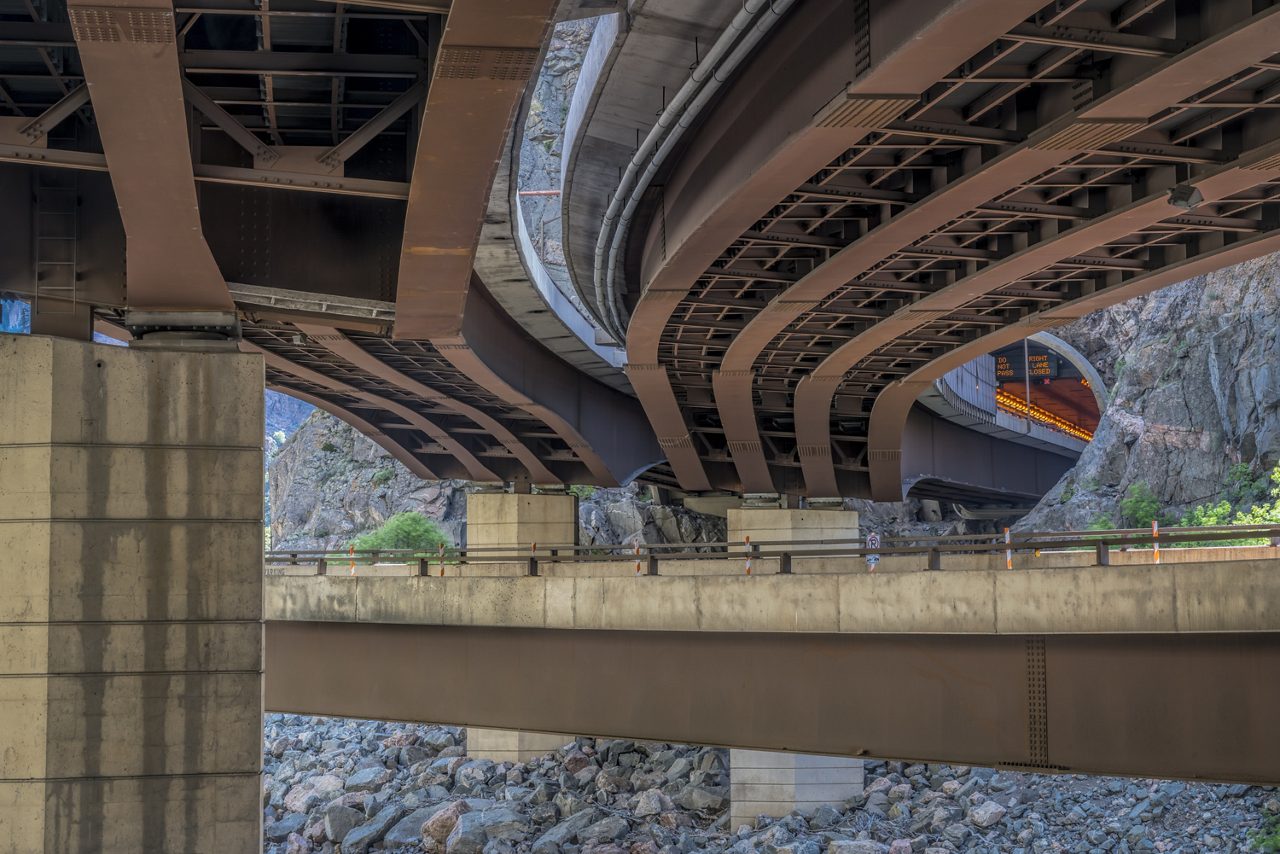 Concrete and steel support beams on underside of elevated highway roads.