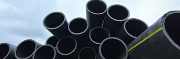 Large black plastic pipes for water supply.