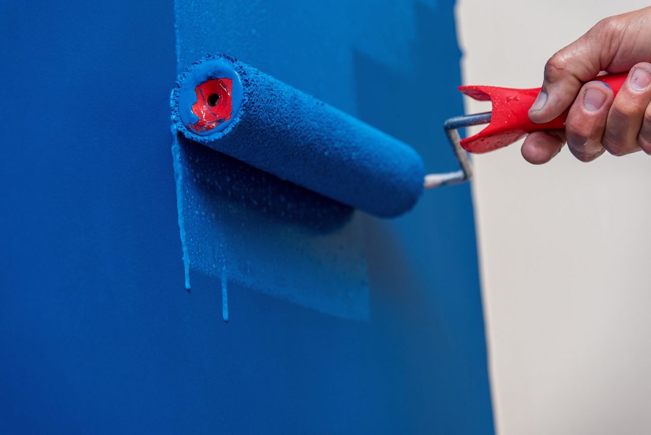 Hand painting wall blue with roller
