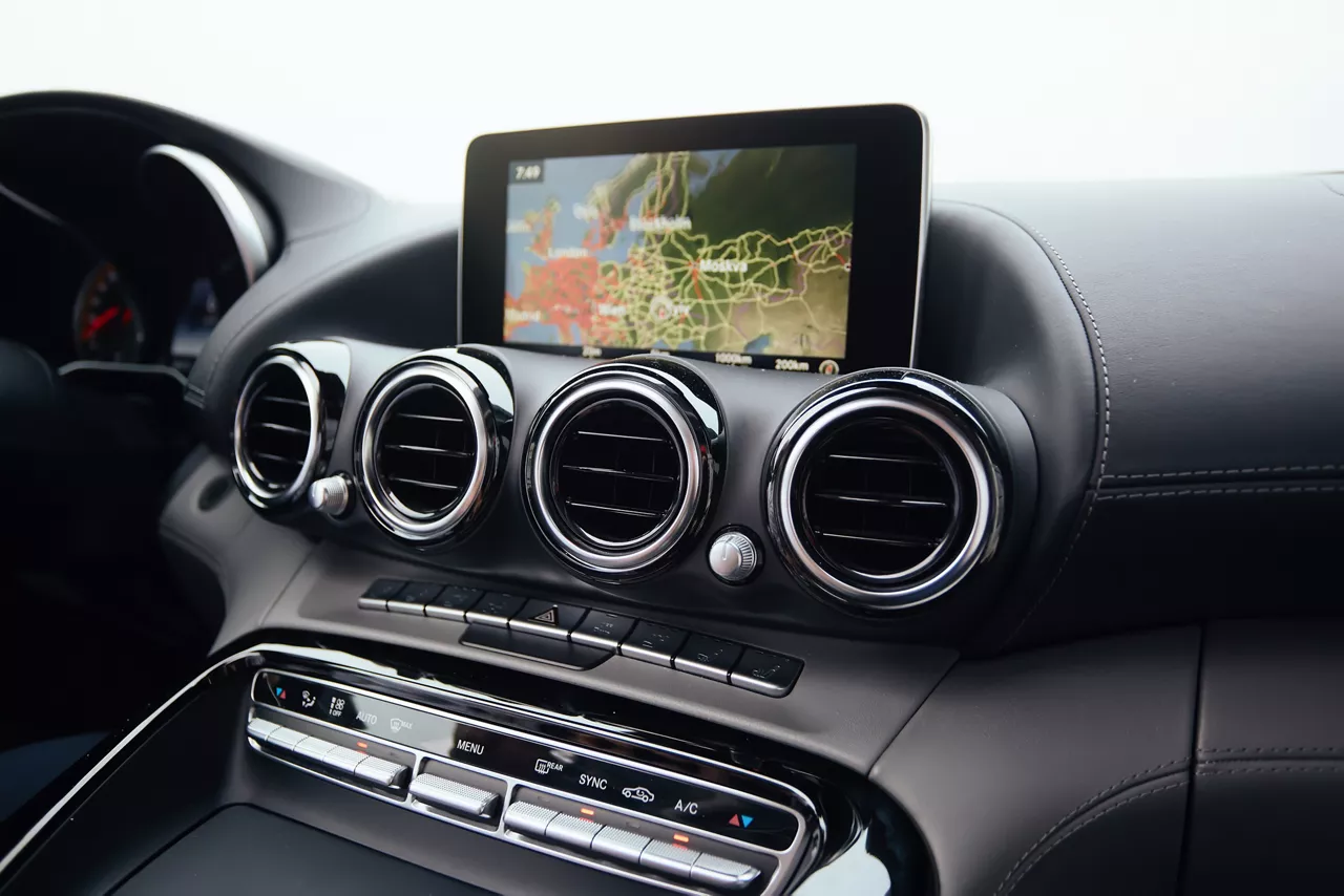 View from inside a car on a part of dashboard with a navigation unit