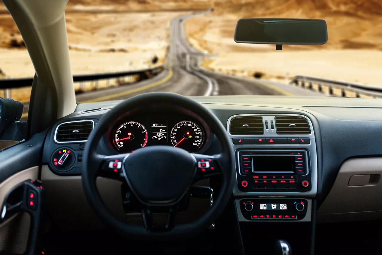 Car dashboard and view of road ahead 