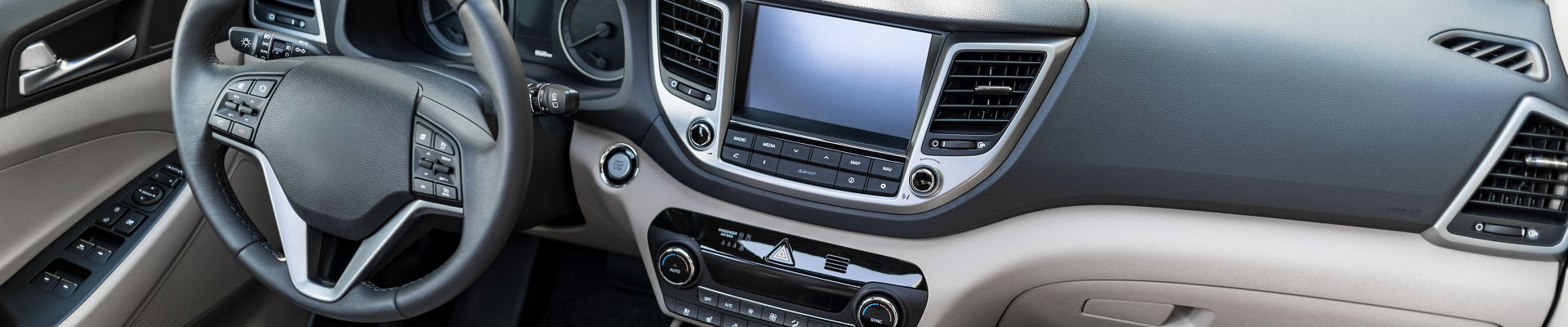 Luxury car interior - steering wheel, shift lever and dashboard.