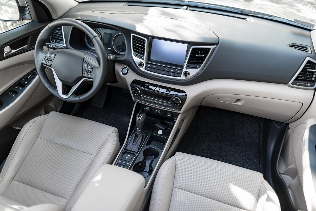 Luxury car interior - steering wheel, shift lever and dashboard.