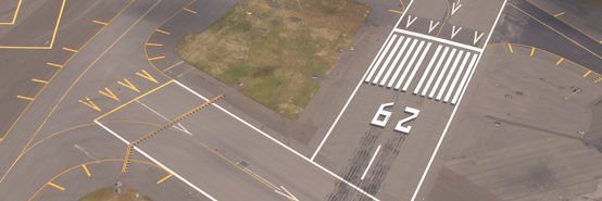 Pavement surface and flight markings on empty runway field at an airport