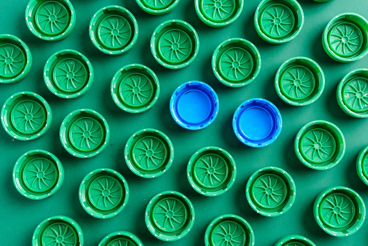 Plastic green caps from bottles and two blue caps