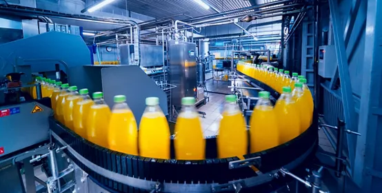 Beverage factory interior showing conveyor with bottles