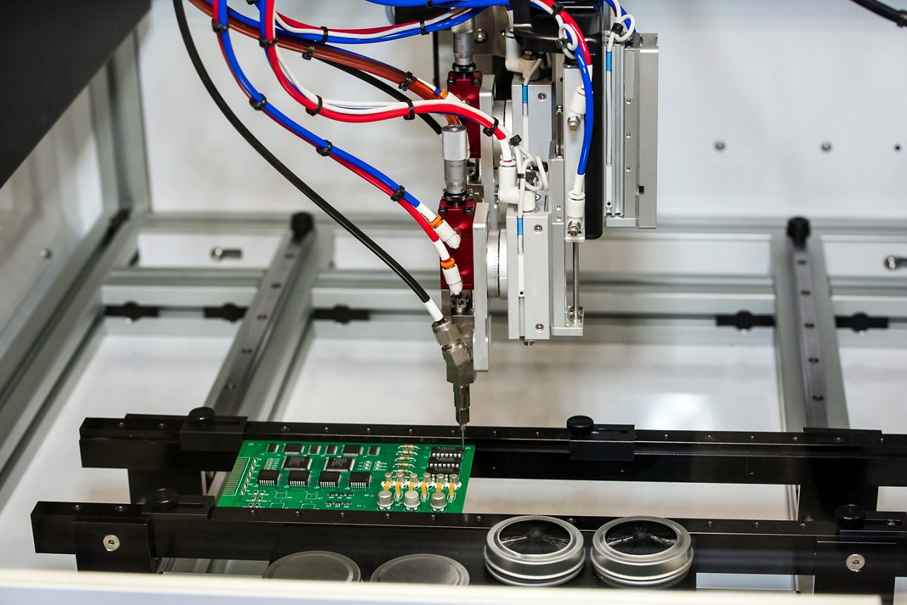 Flexible robotic conformal coating and dispensing system for selective coating potting, bead, and meter-mix dispensing applications.