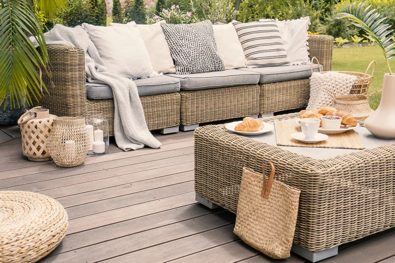 Wicker patio set with beige cushions.