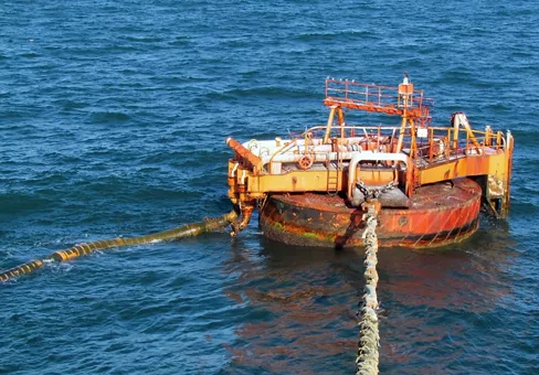 Offshore oil loading from single buoy mooring into oil tanker. Single buoy mooring serves as mooring point for tankers loading and offloading gas and liquids