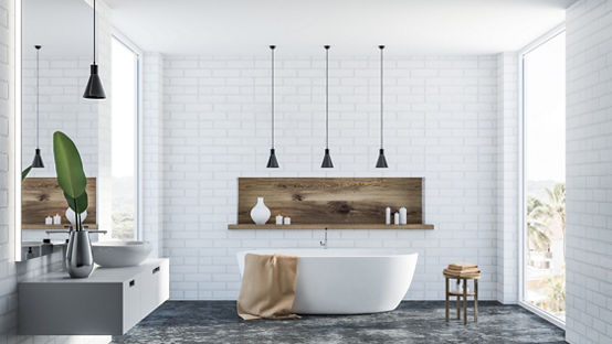 Bathroom with free standing bath on dark tiled floor