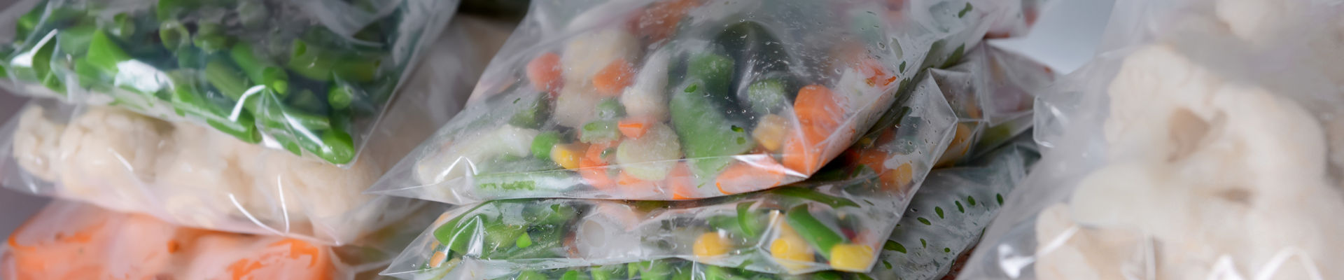 Frozen vegetables in freezer with RETAIN logo