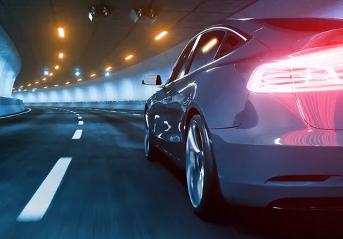 Close up from behind a car driving through tunnel