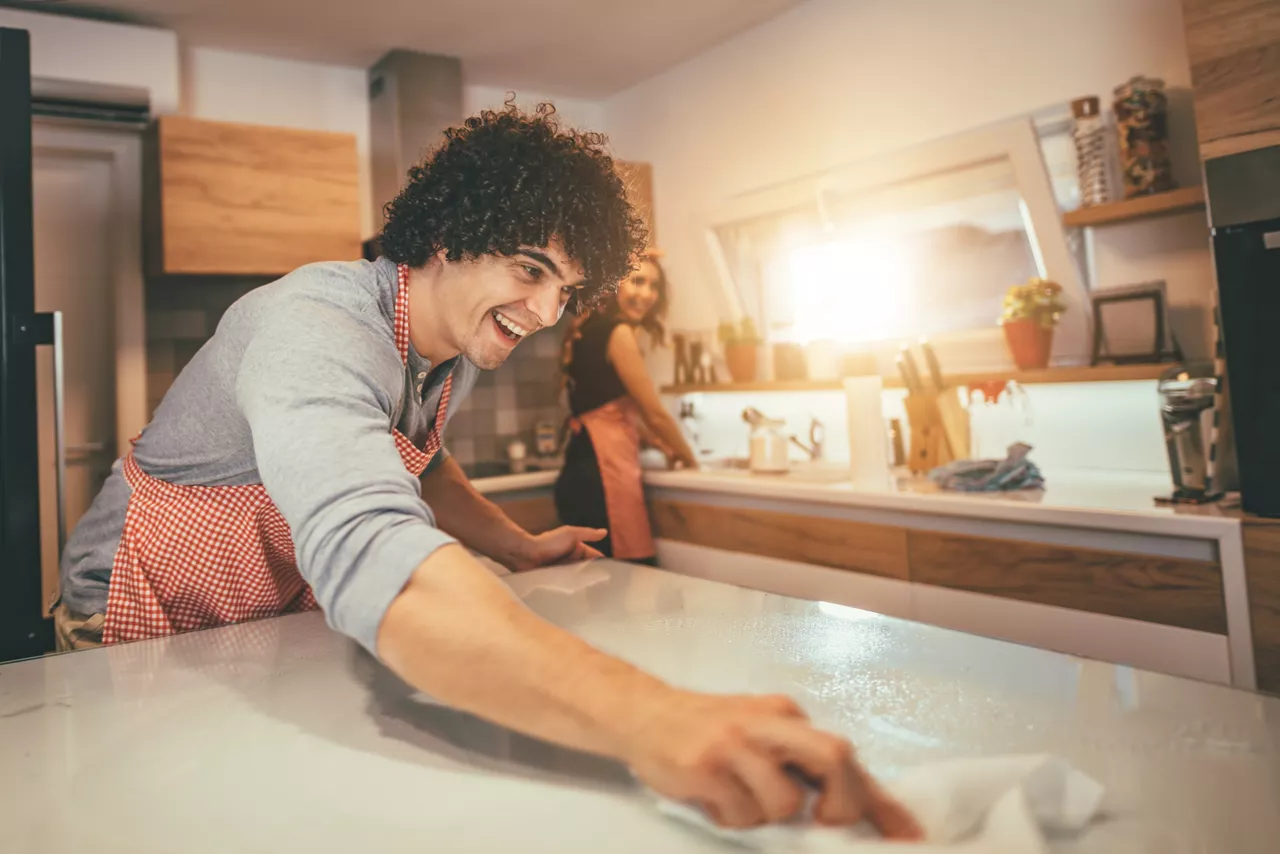 Couple cleaning kitchen 