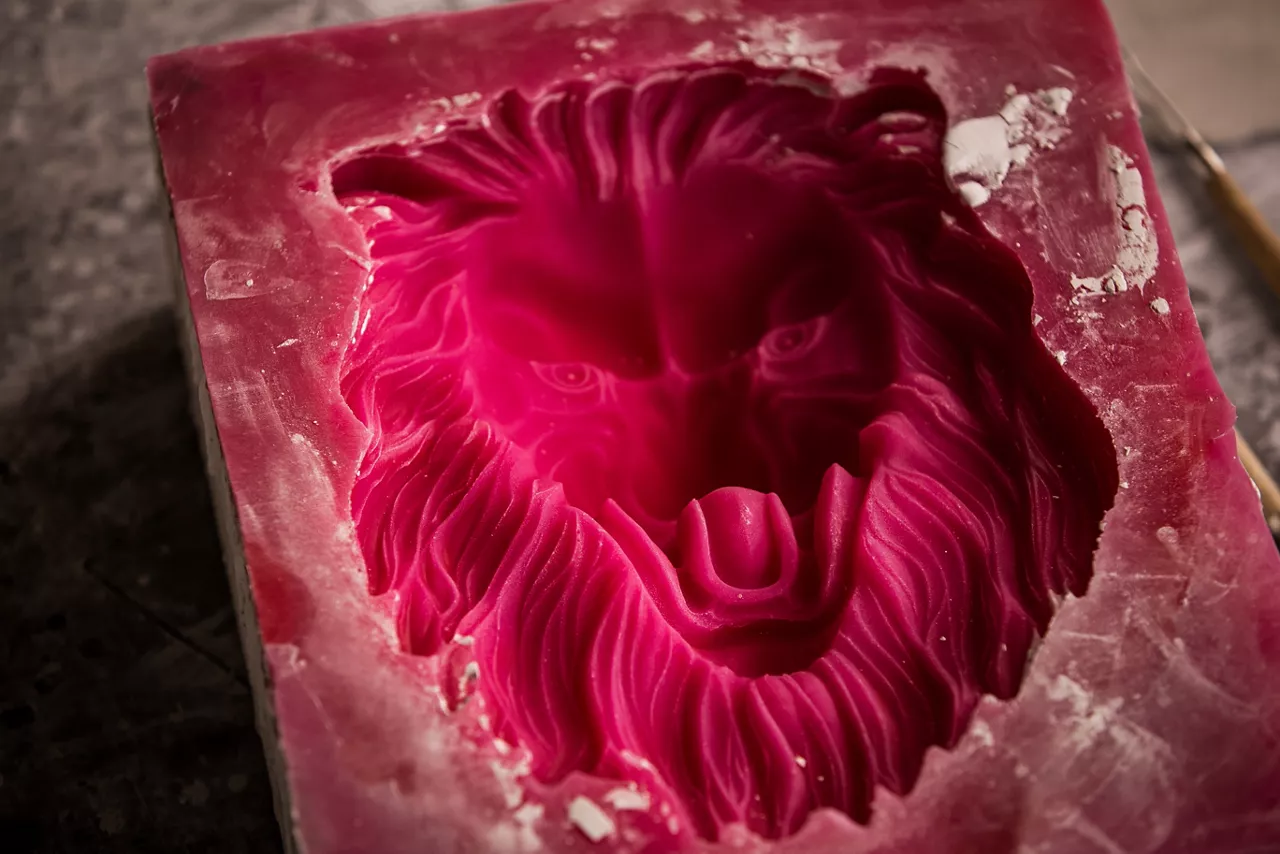 Plaster workshop. Separates the silicone mold from the plaster sculpture of the lion's head