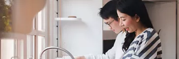 Asian couple family washing dishes together at kitchen
